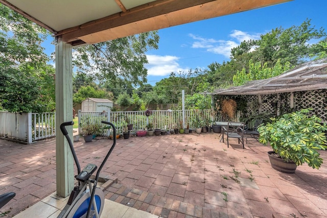 view of patio / terrace featuring a gazebo and a storage unit