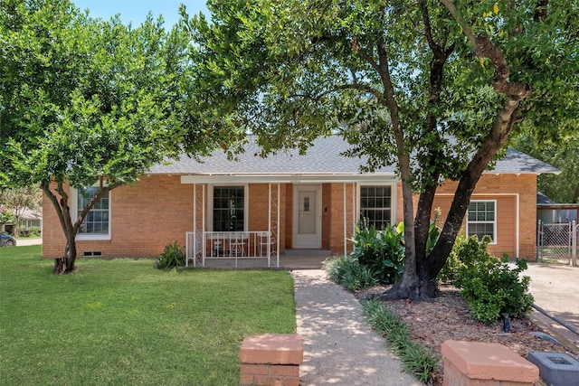 ranch-style house with a front lawn and covered porch