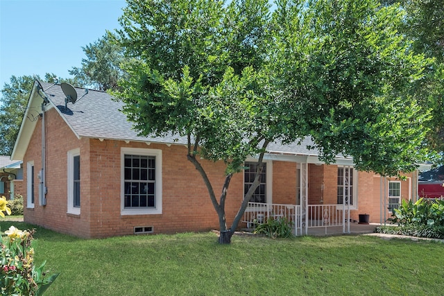 rear view of house featuring a yard