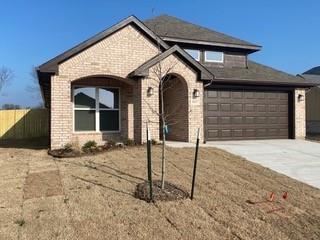 view of front of home featuring a garage and a front lawn