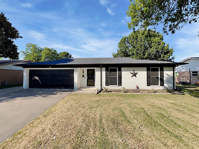 single story home featuring a front yard and a garage