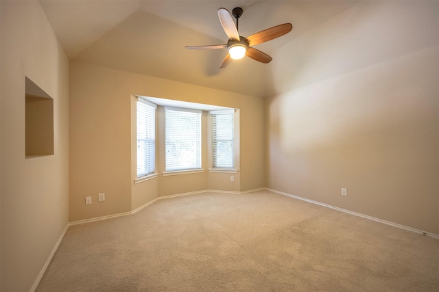 carpeted empty room featuring ceiling fan and lofted ceiling