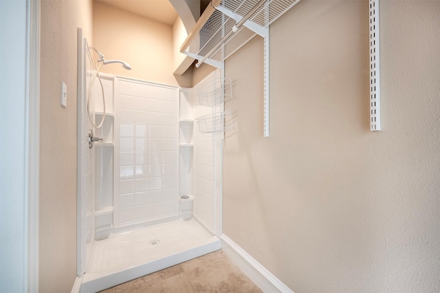 bathroom with walk in shower and tile patterned flooring