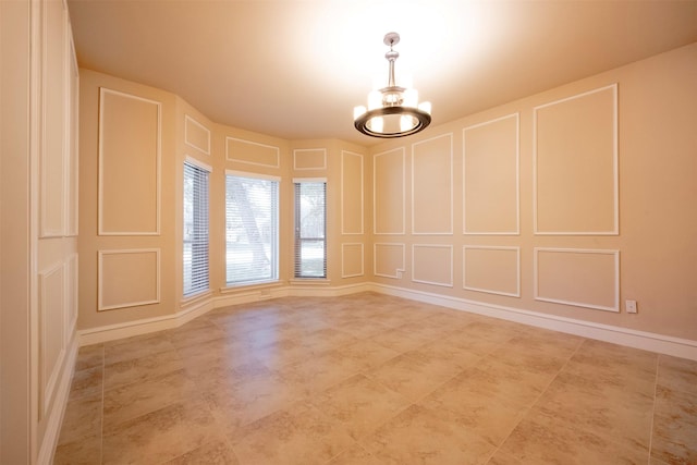 empty room featuring an inviting chandelier