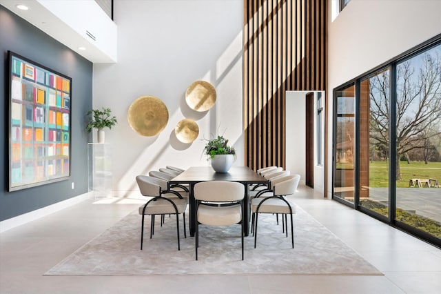 dining space with a towering ceiling