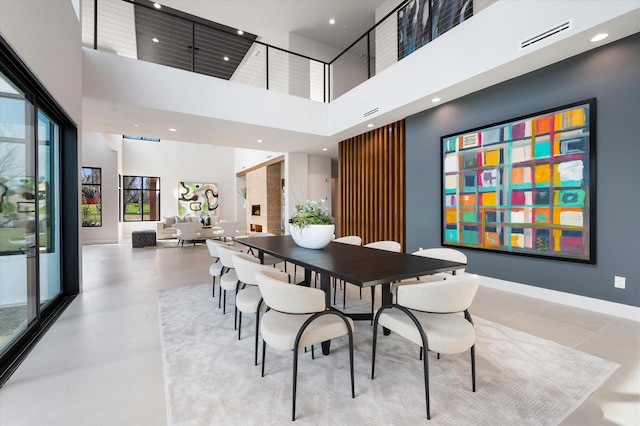 dining space with a towering ceiling