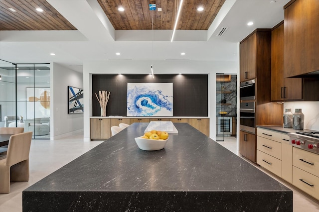 kitchen featuring wood ceiling, a raised ceiling, a spacious island, stainless steel gas cooktop, and beverage cooler