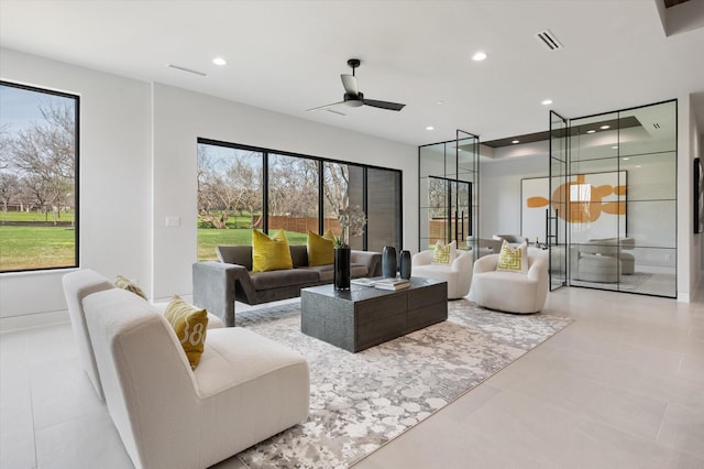 living room with ceiling fan and plenty of natural light