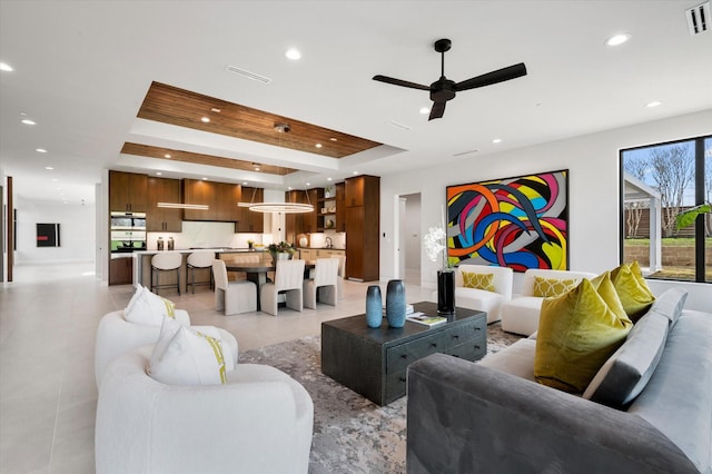 tiled living room with ceiling fan