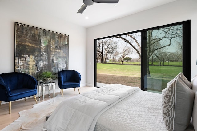 bedroom with ceiling fan and light hardwood / wood-style flooring