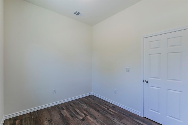 empty room with dark hardwood / wood-style floors