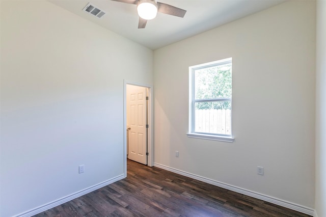 spare room with ceiling fan, dark wood-type flooring, and a wealth of natural light