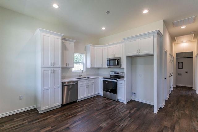 kitchen featuring sink, white cabinetry, dark hardwood / wood-style flooring, and stainless steel appliances