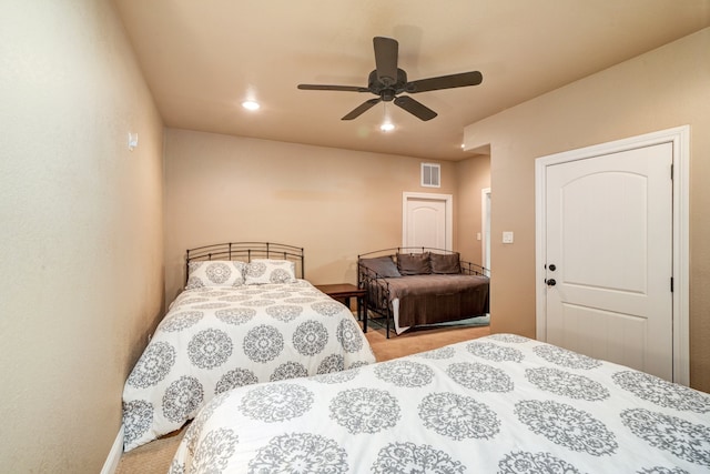 bedroom with light colored carpet and ceiling fan