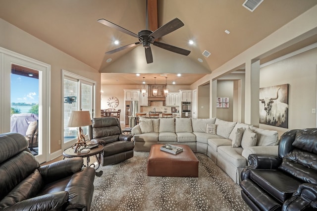 living room featuring ceiling fan and high vaulted ceiling