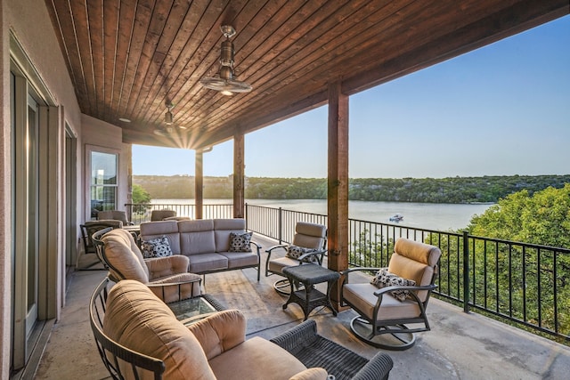 view of patio / terrace with a water view and an outdoor living space