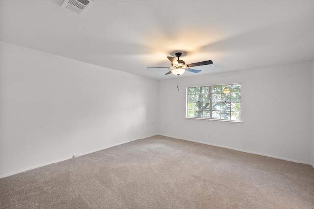 carpeted empty room featuring ceiling fan