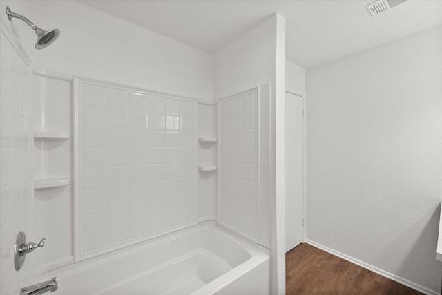 bathroom featuring shower / bathtub combination and hardwood / wood-style flooring