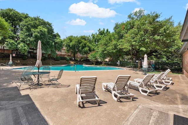 view of swimming pool with a patio area