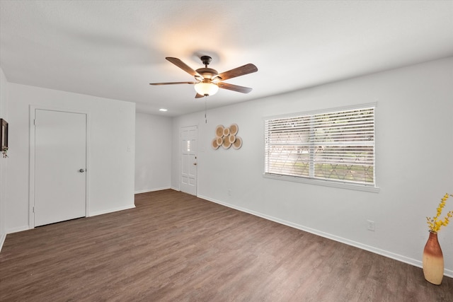 unfurnished room featuring ceiling fan and dark hardwood / wood-style floors