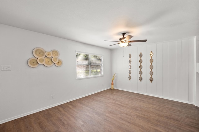 empty room featuring ceiling fan and dark hardwood / wood-style flooring