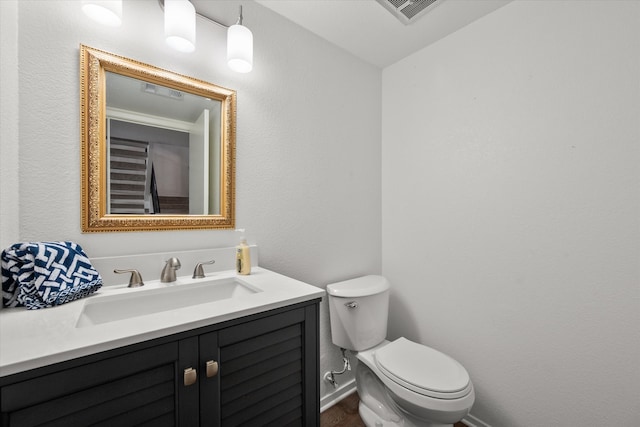 bathroom featuring toilet and vanity