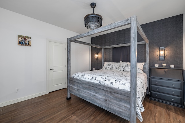 bedroom with dark hardwood / wood-style flooring