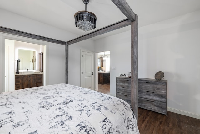 bedroom with dark hardwood / wood-style floors and ensuite bath