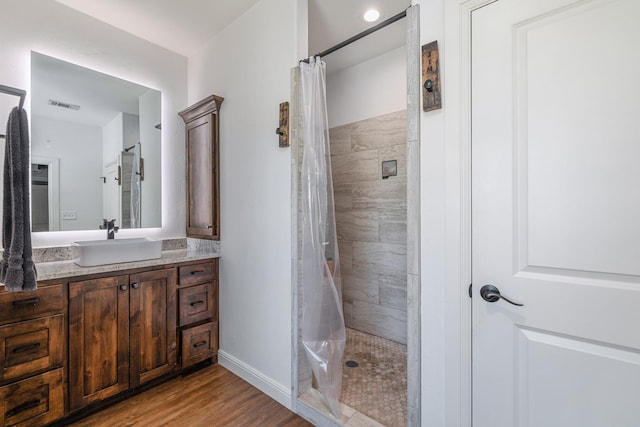 1195 Buck Creek Rd, Tioga, TX 76271 - bathroom featuring wood finished floors, visible vents, vanity, and a tile shower