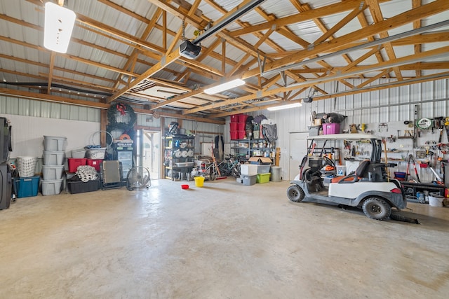 garage with a workshop area and a garage door opener