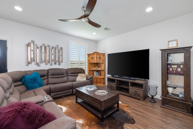 living room featuring hardwood / wood-style floors and ceiling fan