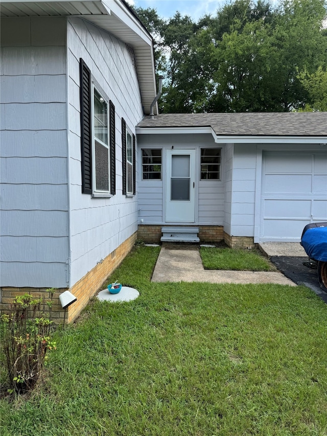 view of exterior entry with a lawn