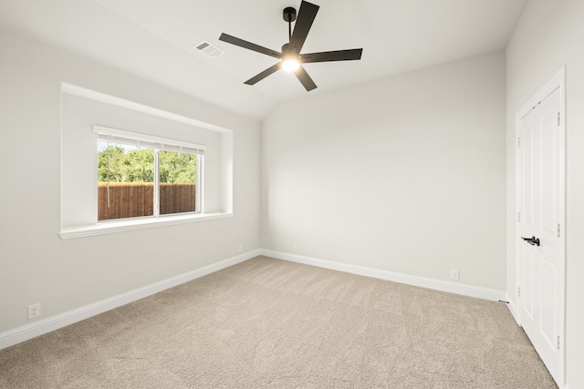 unfurnished room with light carpet, ceiling fan, and lofted ceiling