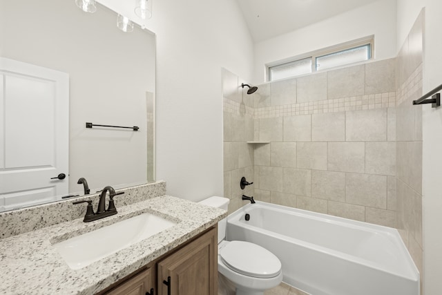 full bathroom featuring vanity, vaulted ceiling, toilet, and tiled shower / bath combo