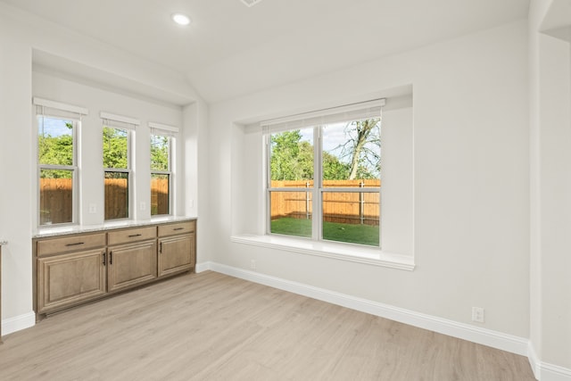 unfurnished sunroom with vaulted ceiling