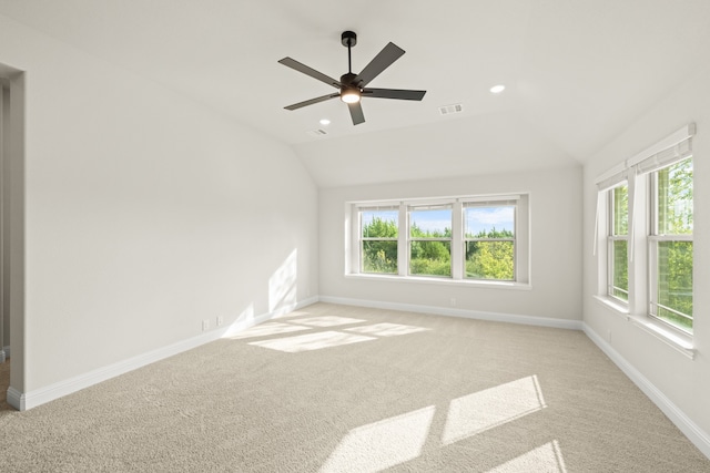 empty room featuring vaulted ceiling, ceiling fan, and light colored carpet