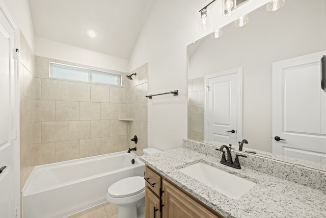 full bathroom with toilet, vanity, lofted ceiling, and tiled shower / bath