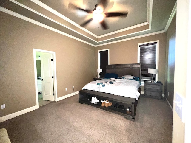 bedroom featuring ensuite bathroom, ornamental molding, a raised ceiling, ceiling fan, and carpet