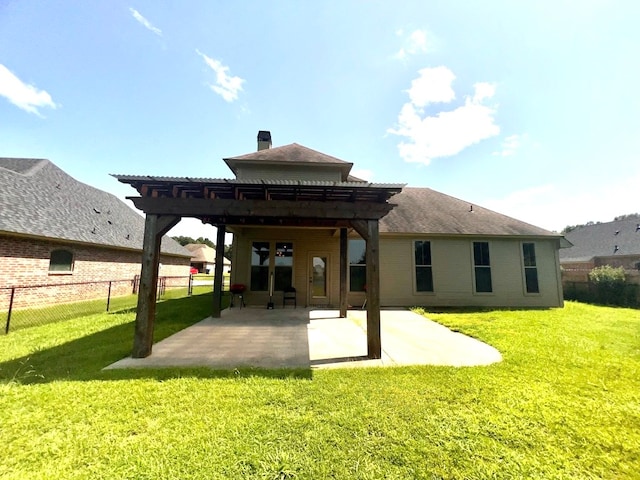 rear view of house with a patio, a yard, and a pergola