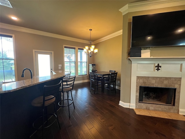 dining space featuring ornamental molding, dark hardwood / wood-style floors, and a notable chandelier