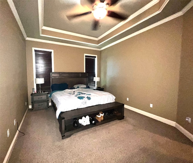 carpeted bedroom featuring crown molding, a raised ceiling, and ceiling fan