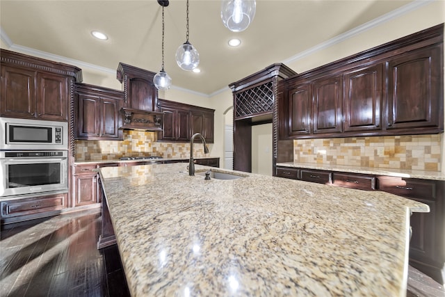 kitchen with backsplash, light stone counters, dark hardwood / wood-style floors, appliances with stainless steel finishes, and sink