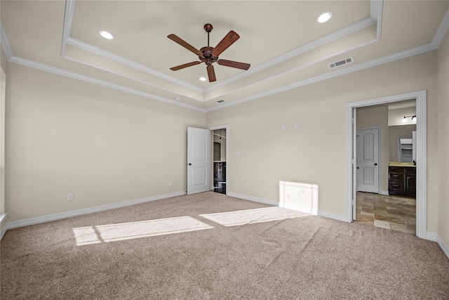 unfurnished room featuring carpet flooring, a raised ceiling, crown molding, and ceiling fan