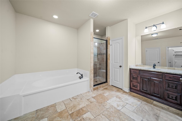 bathroom featuring tile patterned flooring, separate shower and tub, and vanity