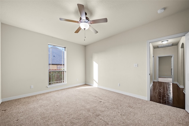 carpeted spare room featuring ceiling fan