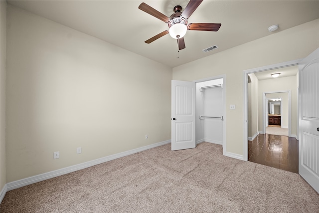 unfurnished bedroom featuring carpet flooring, a closet, and ceiling fan