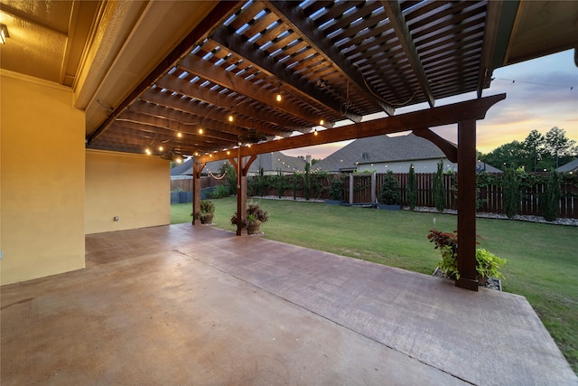 patio terrace at dusk with a lawn and a pergola