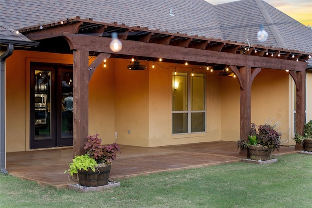 patio terrace at dusk with a yard and french doors