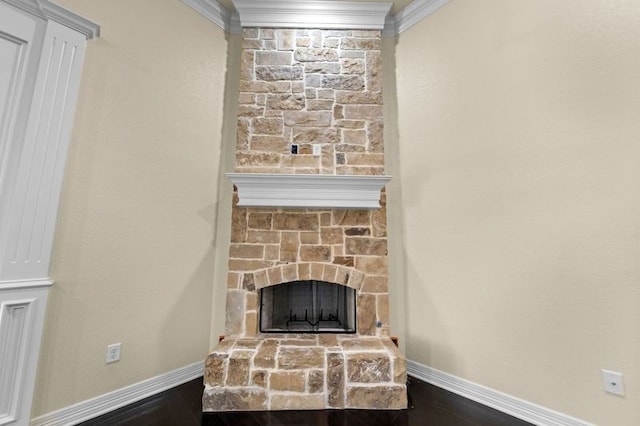 details with a stone fireplace, crown molding, and hardwood / wood-style floors