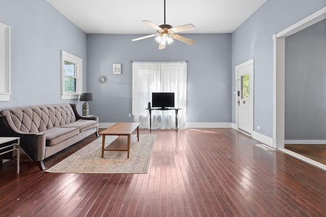 living area with ceiling fan, hardwood / wood-style flooring, and baseboards